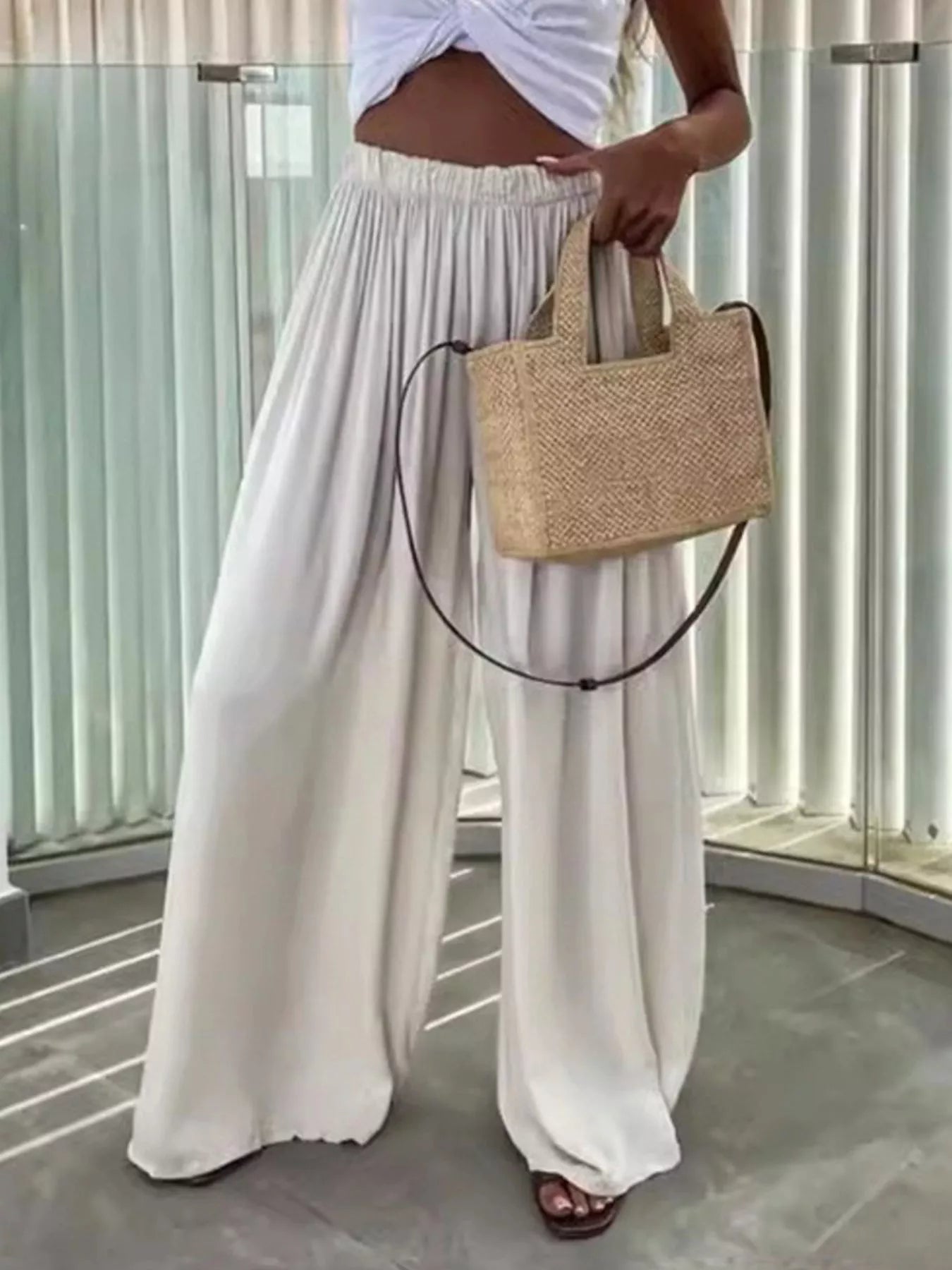 Flowy wide-leg pants from Trendsi featuring lightweight, relaxed fit fabric with a high waist and flowing silhouette.