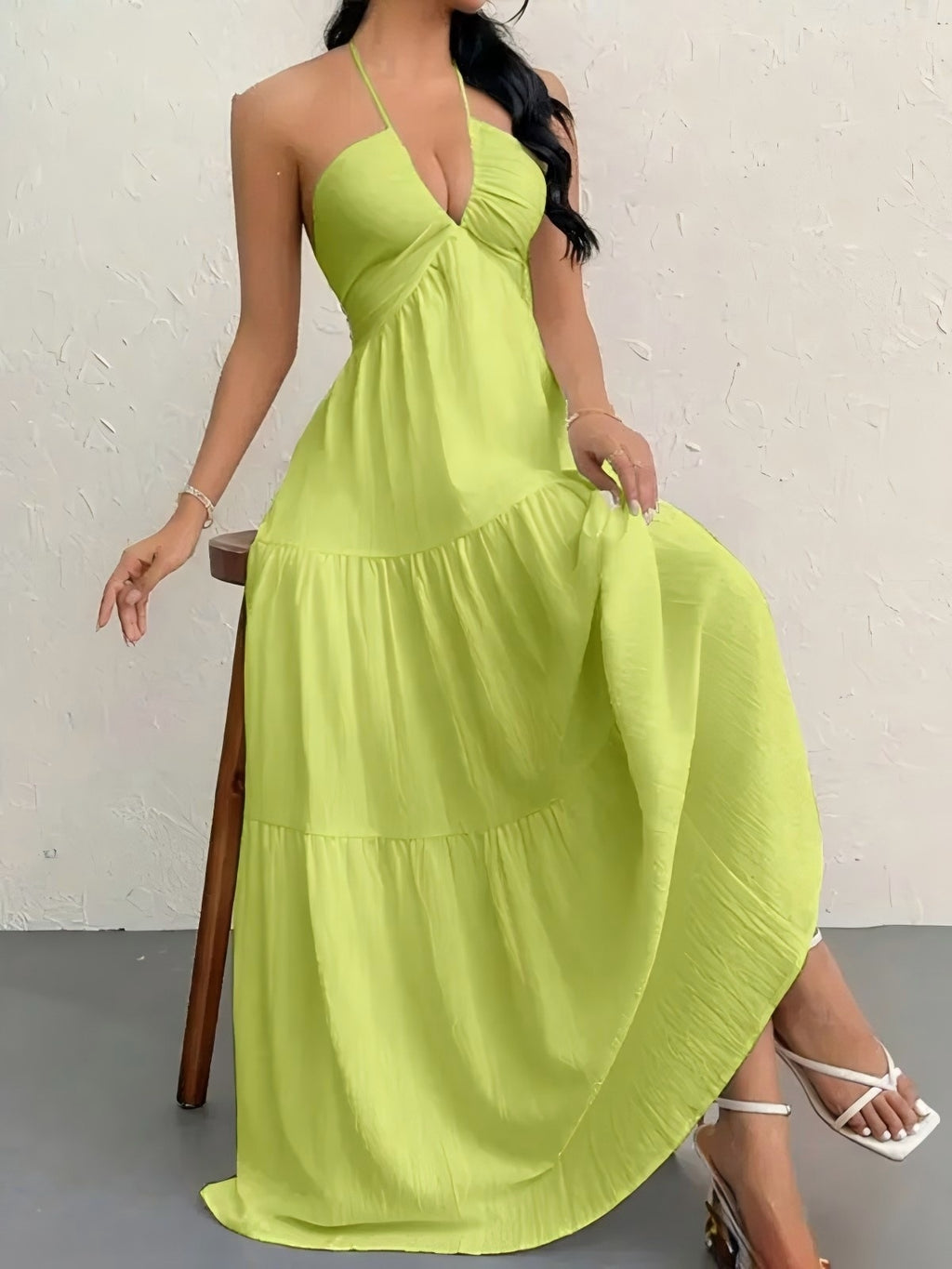 Lime green halter-neck maxi dress with a gathered bodice and tiered, flowing skirt.