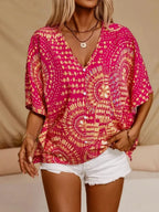 Women's printed V-neck half sleeve casual top by Trendsi, soft stretch fabric, stylish office blouse with vibrant print design.