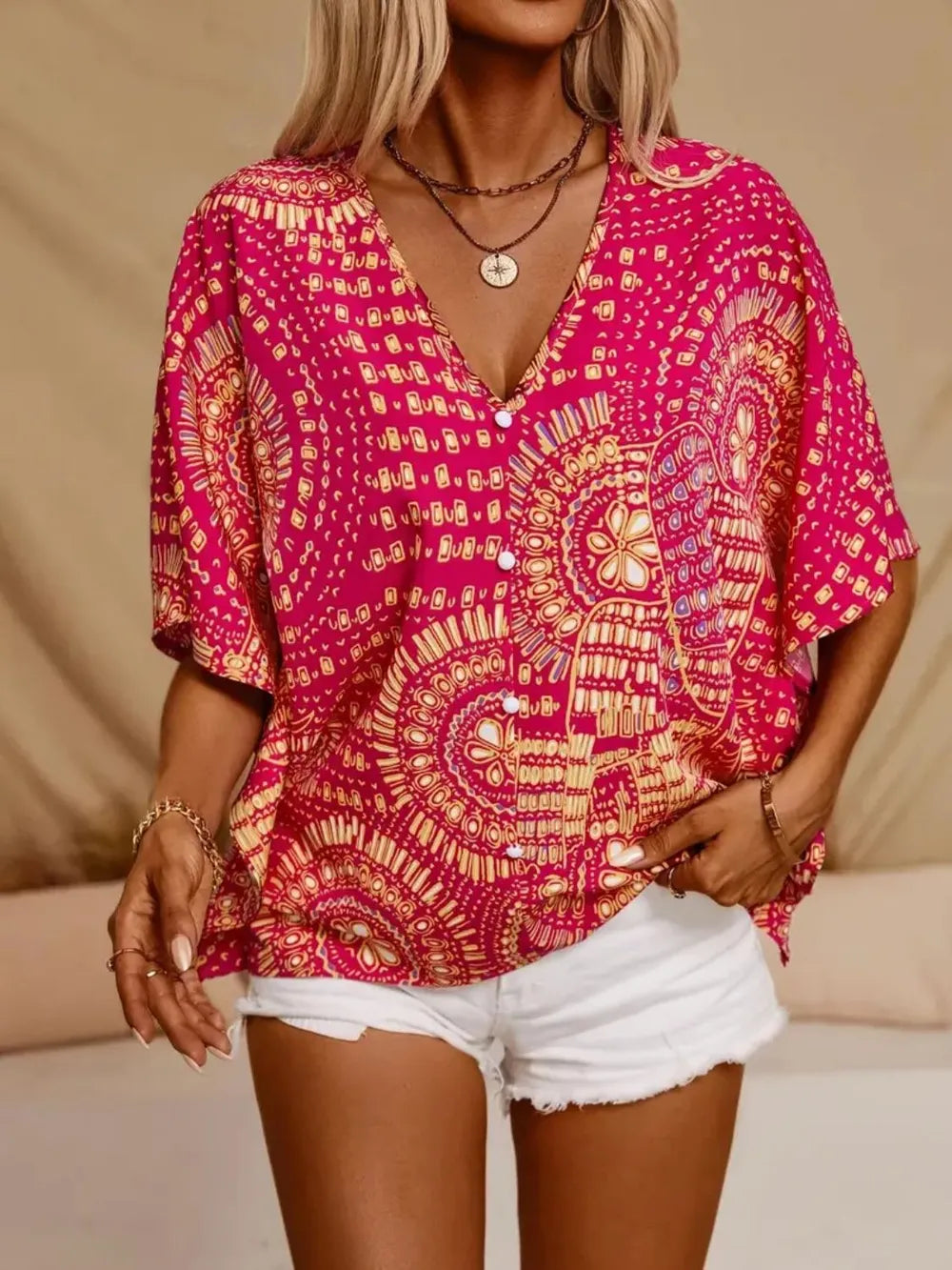 Women's printed V-neck half sleeve casual top by Trendsi, soft stretch fabric, stylish office blouse with vibrant print design.