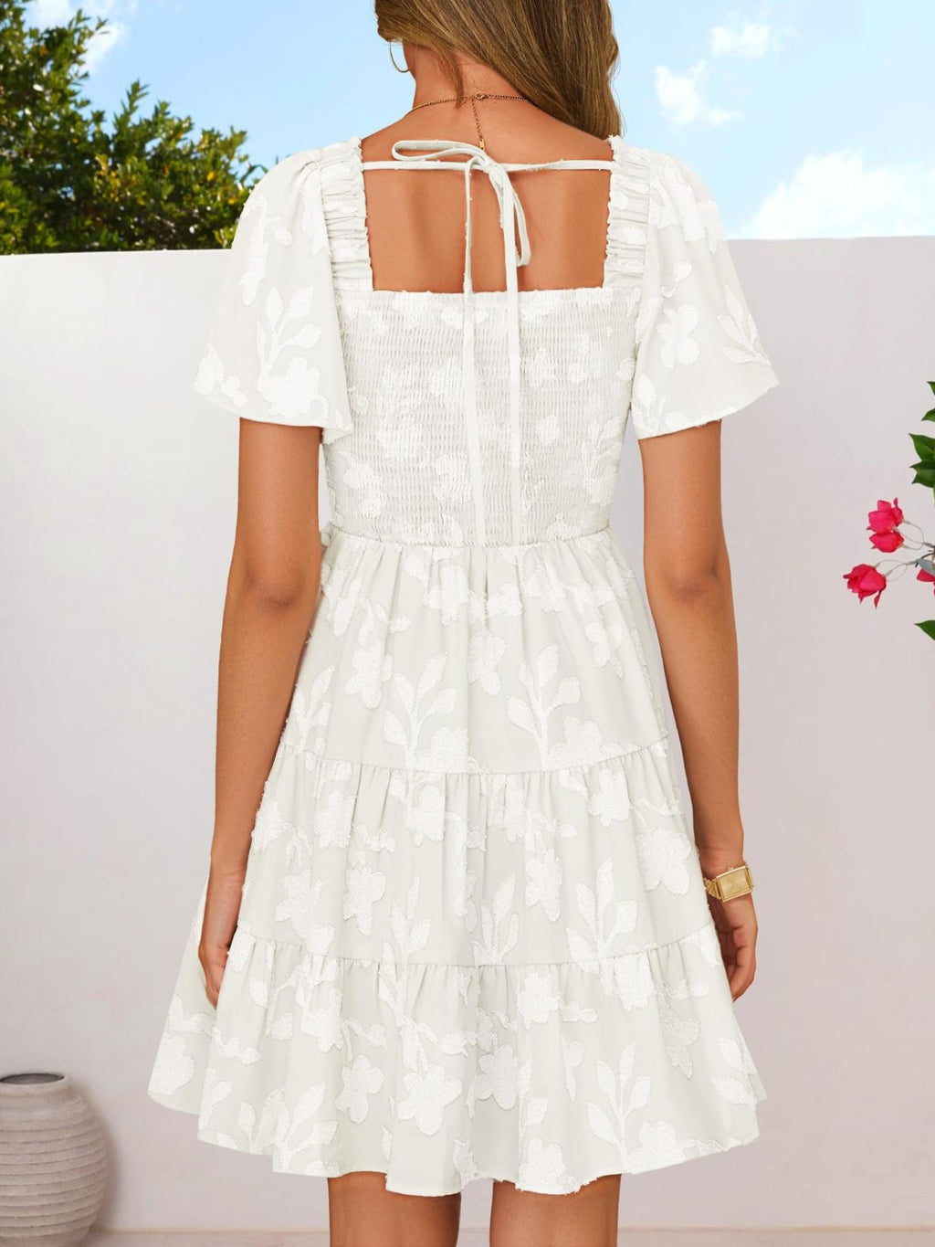 Women's smocked tiered square neck short sleeve casual dress with pockets, featuring a relaxed fit and stylish design.