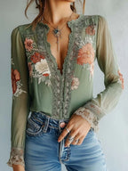 Elegant floral lace blouse by Trendsi featuring long sleeves and a sophisticated feminine design.