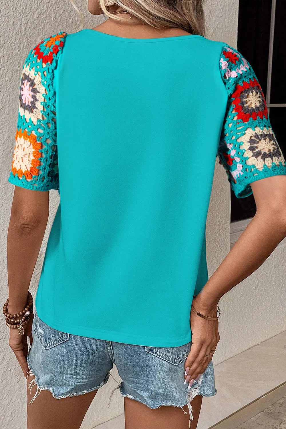 Geometric print round neck short sleeve blouse from Trendsi, featuring a stylish pattern and a relaxed fit.