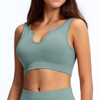 Sage green ribbed athletic crop top with a notched U-neckline and thick shoulder straps.