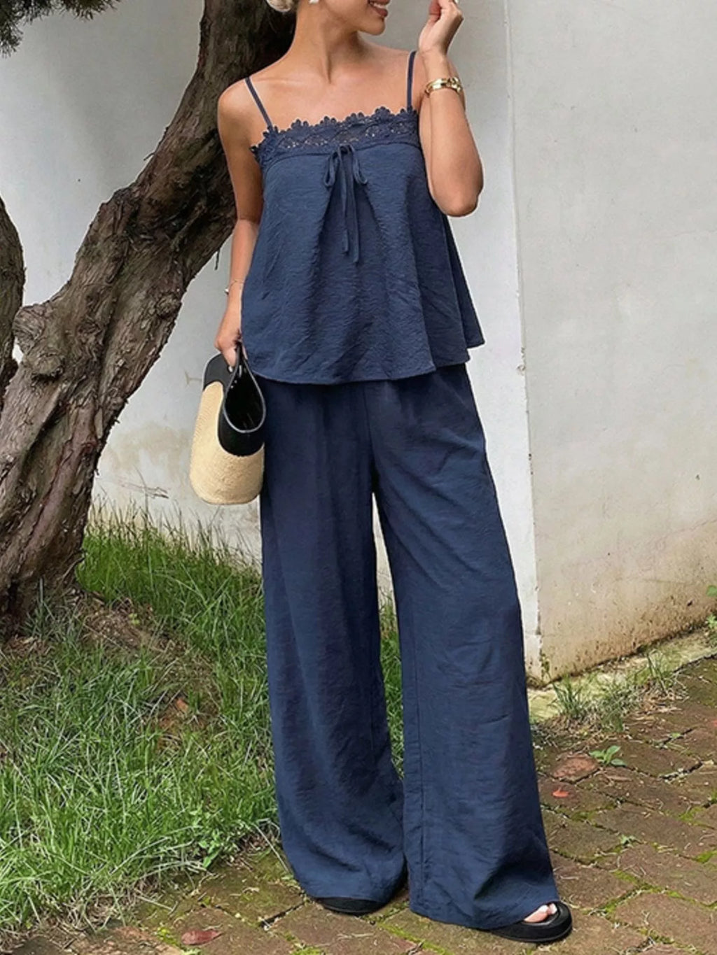 Lace trim camisole and wide-leg pants set from Trendsi, featuring a stylish, comfortable design with delicate lace details.