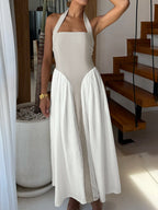 Elegant two-tone halter neck maxi dress with ruched details and side pockets, perfect for stylish summer occasions.
