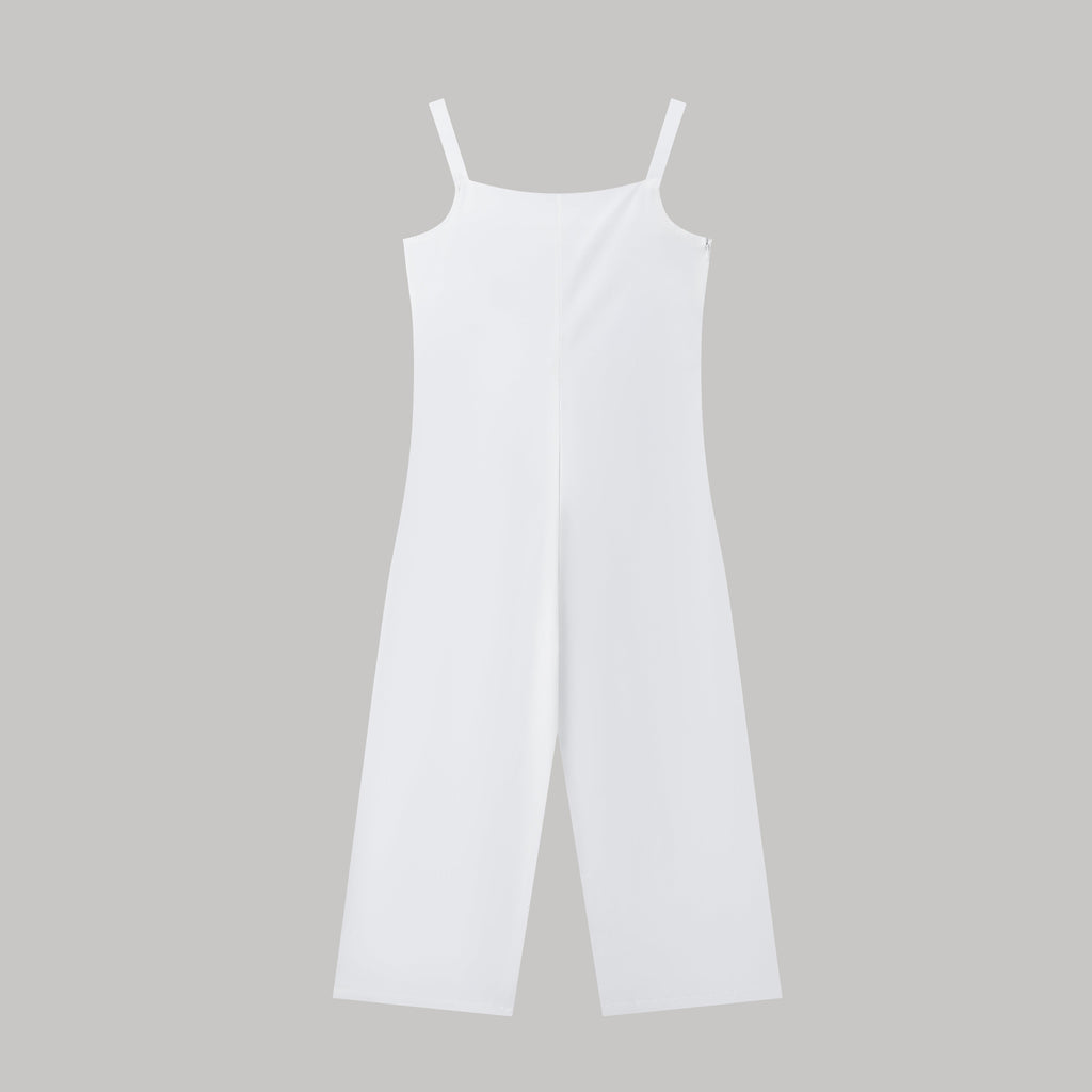 Minimalist white spaghetti strap jumpsuit with a wide-leg silhouette against a plain grey background.
