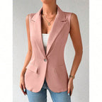 A dusty pink sleeveless blazer with lapels, a single front button, and two side flap pockets over a white top.