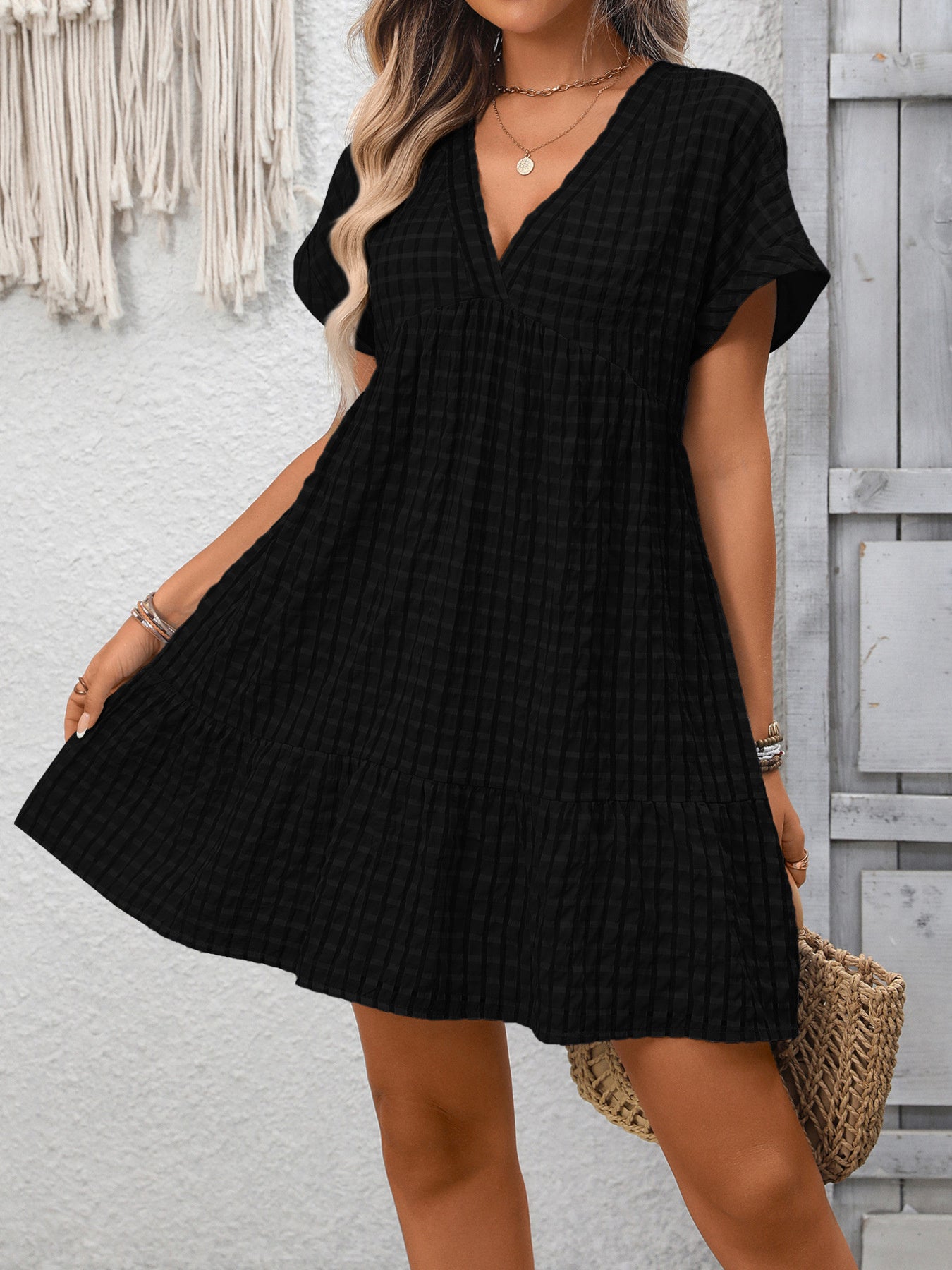 Lightweight plaid V-neck mini dress with ruffle hem from Trendsi, perfect for seasonal fashion and casual wear.