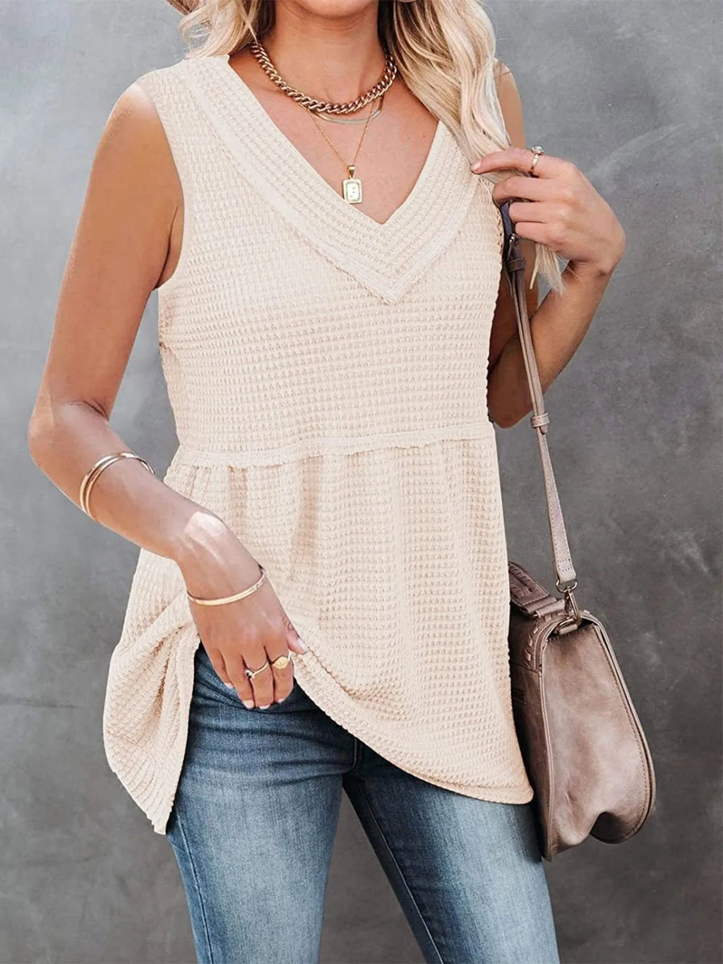 V-neck waffle knit tank top with contrast stitching in beige and brown, featuring a relaxed fit and sleeveless design from Trendsi.