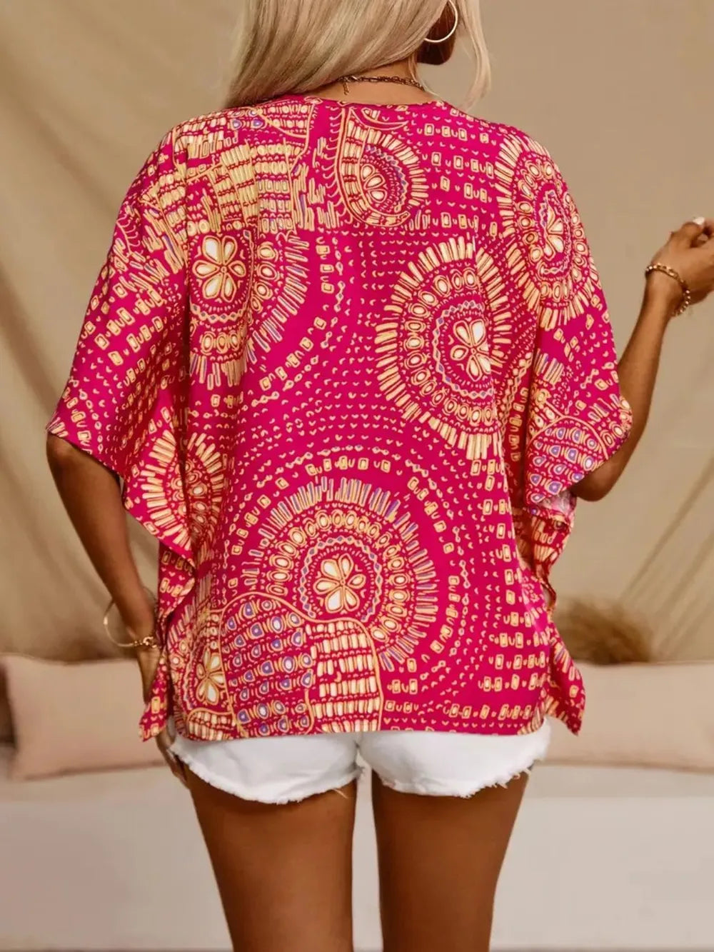 Women's printed V-neck casual top by Trendsi, soft stretch fabric, half sleeves, perfect for office or casual wear.