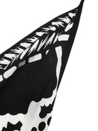 Women's printed halter neck maxi dress with tie-back detail, featuring a flowy silhouette and vibrant floral pattern.