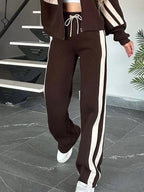 Plus size contrast stripe zip-up activewear jacket and pants set by Plush Fashion Hub, featuring bold stripes and full-length design.