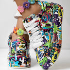 Colorful pop-art print sneakers with white laces and a vibrant, multi-colored floral anklet on a person's foot.