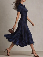 Pleated striped short sleeve midi dress by Trendsi with a flowy silhouette and stylish pattern, perfect for casual or semi-formal wear.