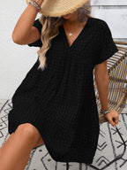 Lightweight plaid V-neck mini dress with ruffle hem from Trendsi, perfect for seasonal fashion, shown on a model.