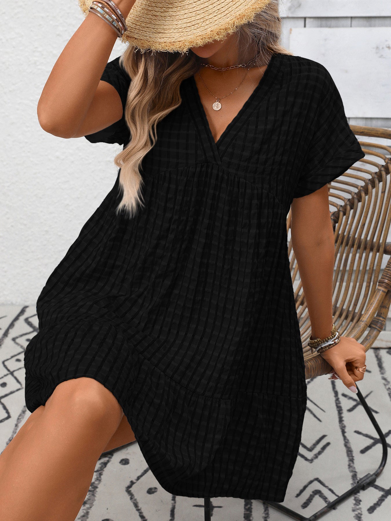 Lightweight plaid V-neck mini dress with ruffle hem from Trendsi, perfect for seasonal fashion, shown on a model.