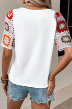 Geometric print round neck short sleeve blouse from Trendsi, featuring a stylish pattern and casual fit, ideal for everyday wear.