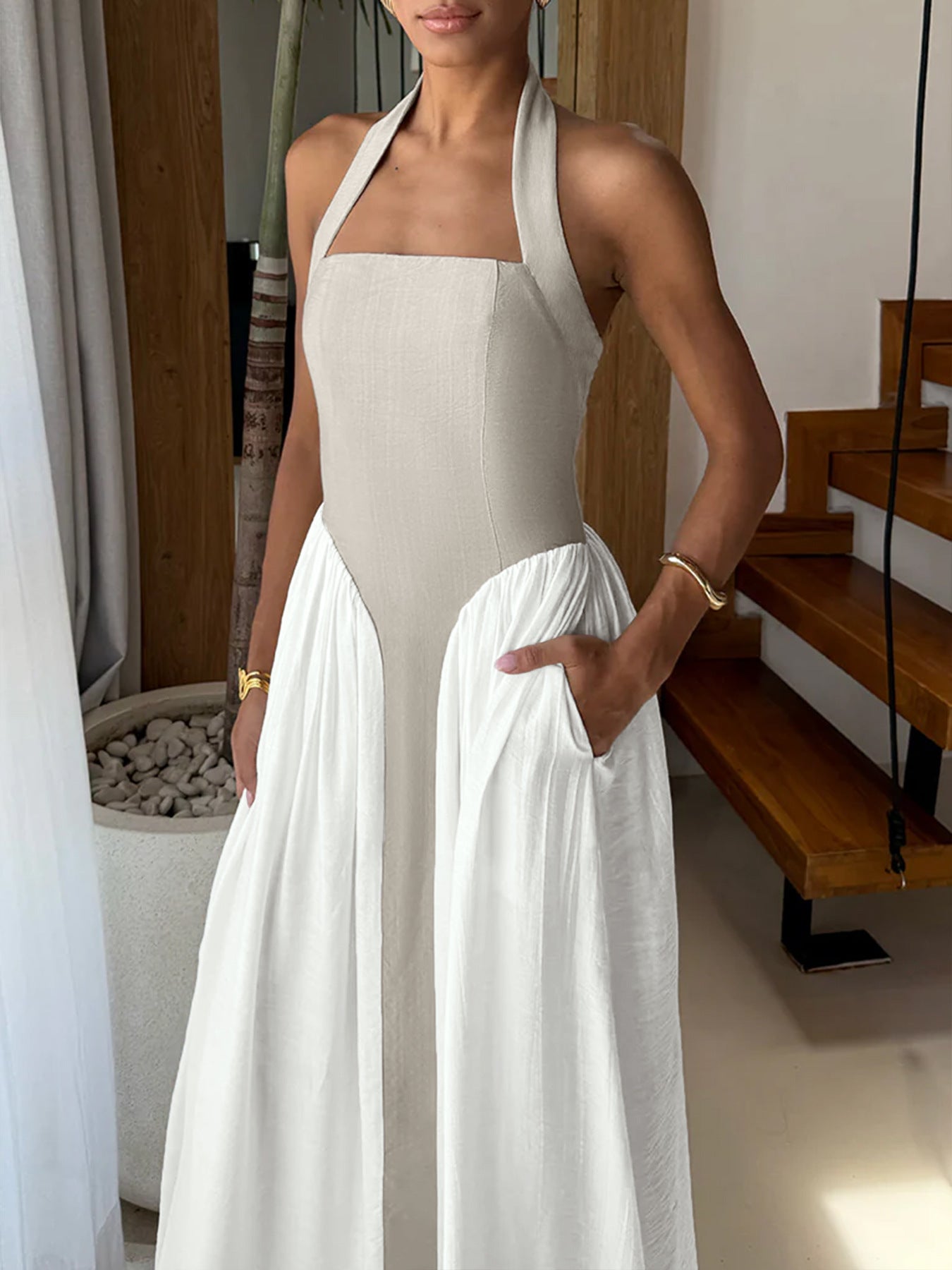 Elegant two-tone halter neck maxi dress with ruched design and side pockets, perfect for stylish and comfortable summer wear.