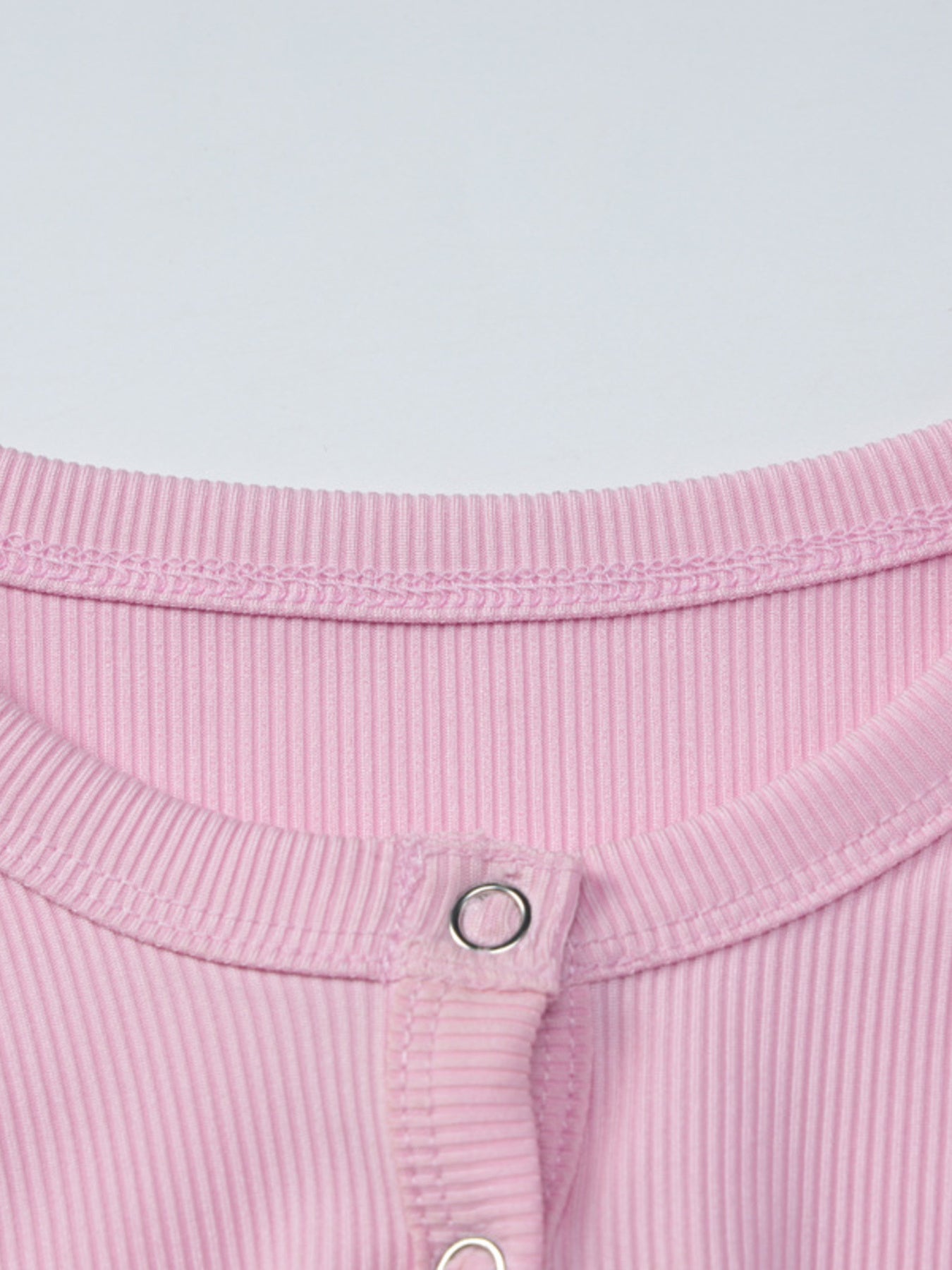 Women's ribbed knit button-front long sleeve T-shirt from Trendsi, featuring a fitted design and classic ribbed texture.