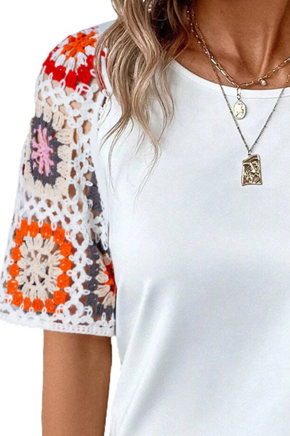 Geometric print round neck short sleeve blouse by Trendsi, featuring a stylish pattern and comfortable fit.