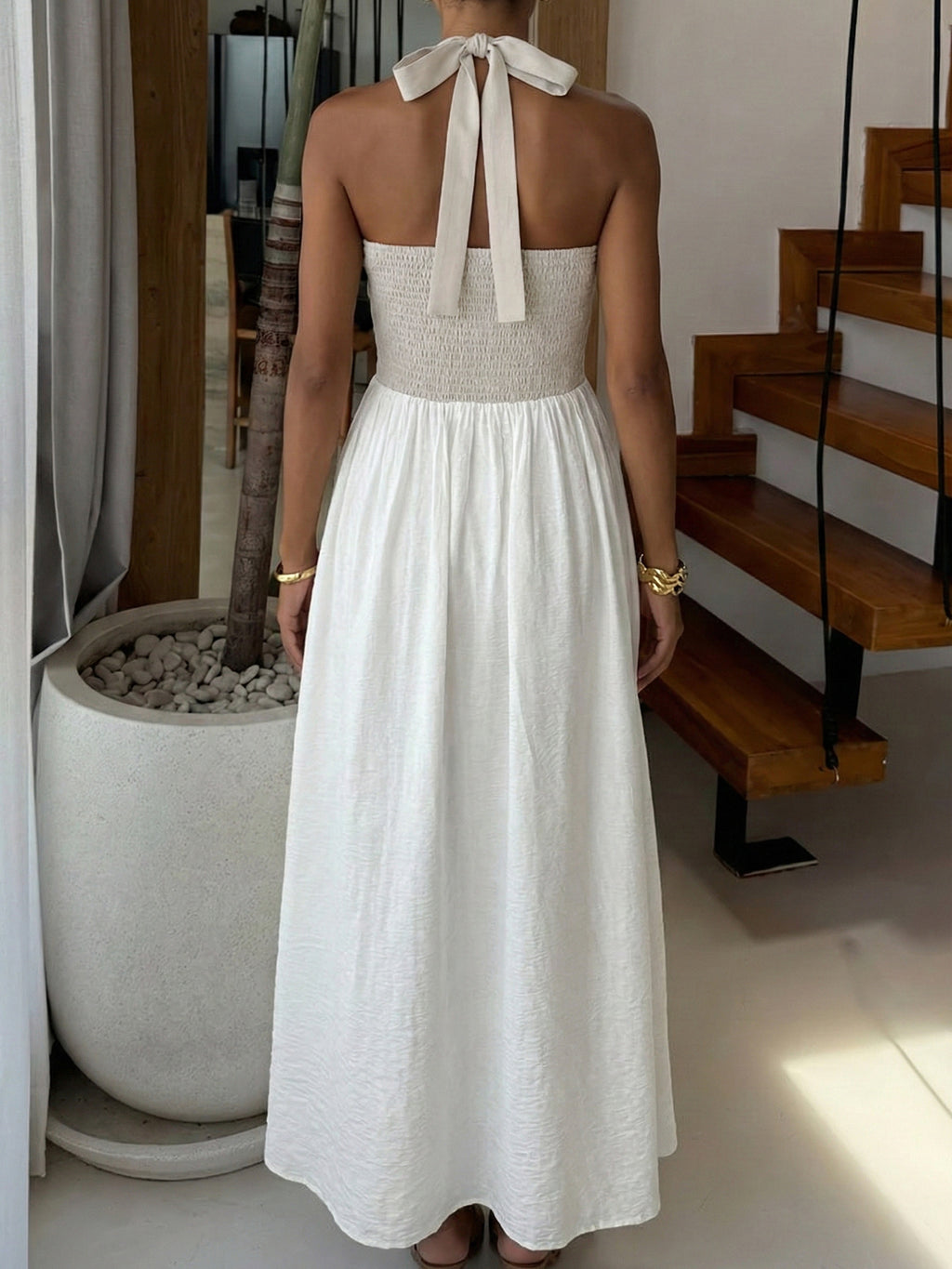 Elegant two-tone halter neck maxi dress with ruched details and pockets, perfect for stylish occasions.