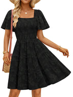 Women's smocked tiered square neck casual dress with short sleeves and pockets by Trendsi, featuring a feminine and relaxed style.
