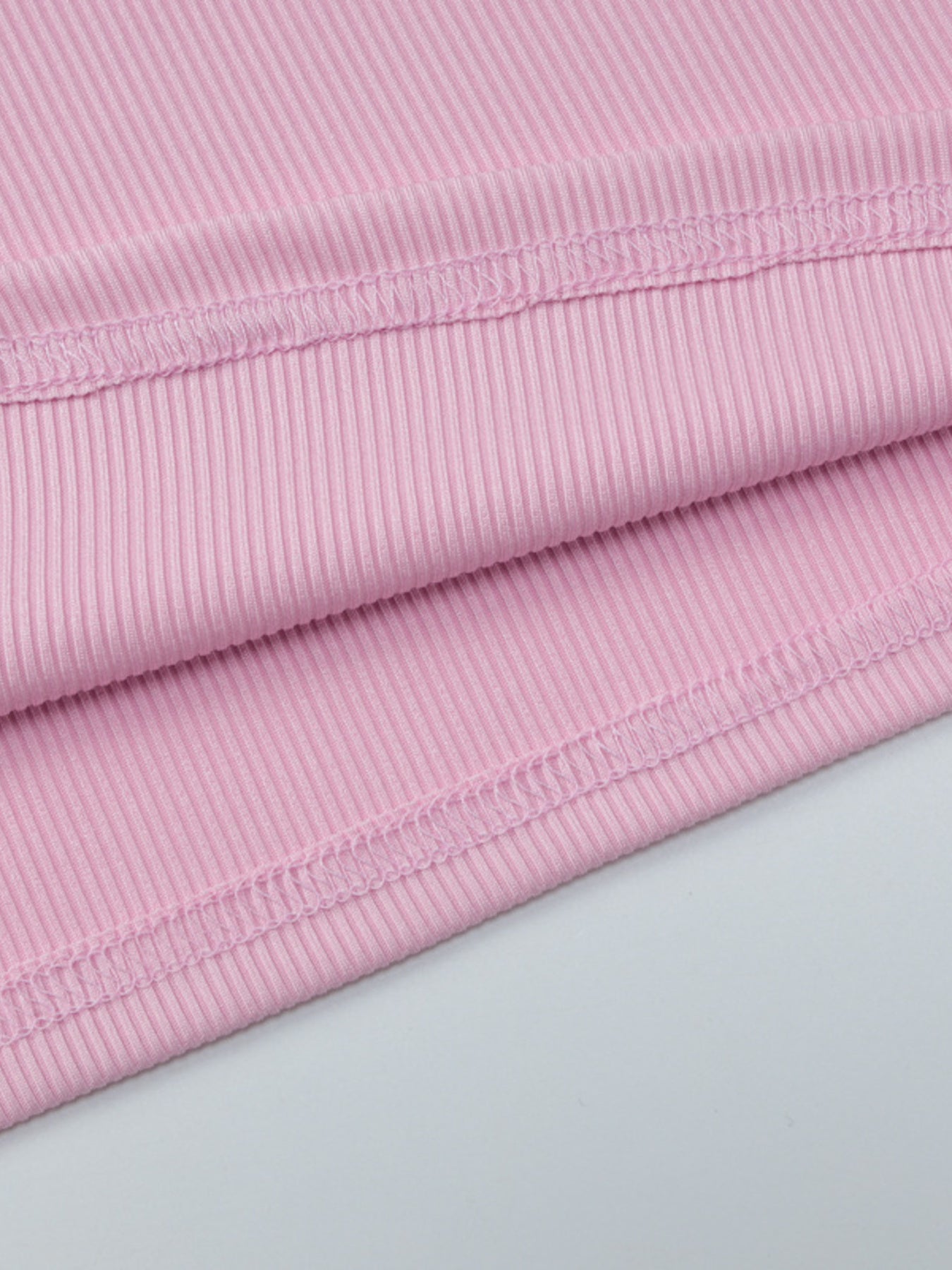 Women's ribbed knit button-front long sleeve T-shirt from Trendsi, shown in a close-up of the soft fabric and stylish design.