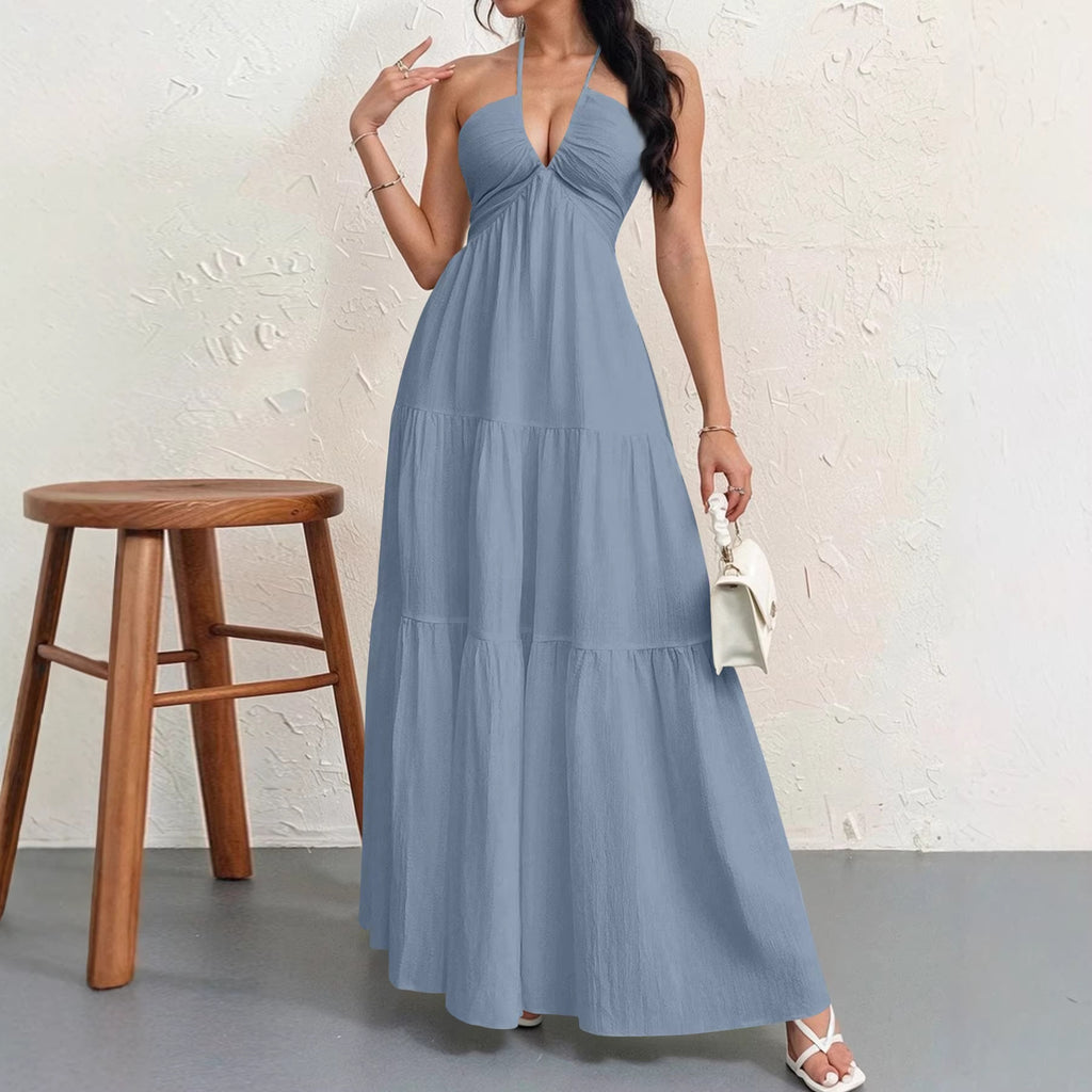 Dusty blue halter-neck maxi dress with a ruched bodice and a tiered, flowing skirt.