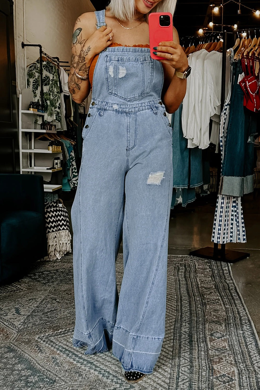 Women’s distressed wide-leg denim overalls by Trendsi, casual relaxed fit jeans with distressed details and adjustable straps.