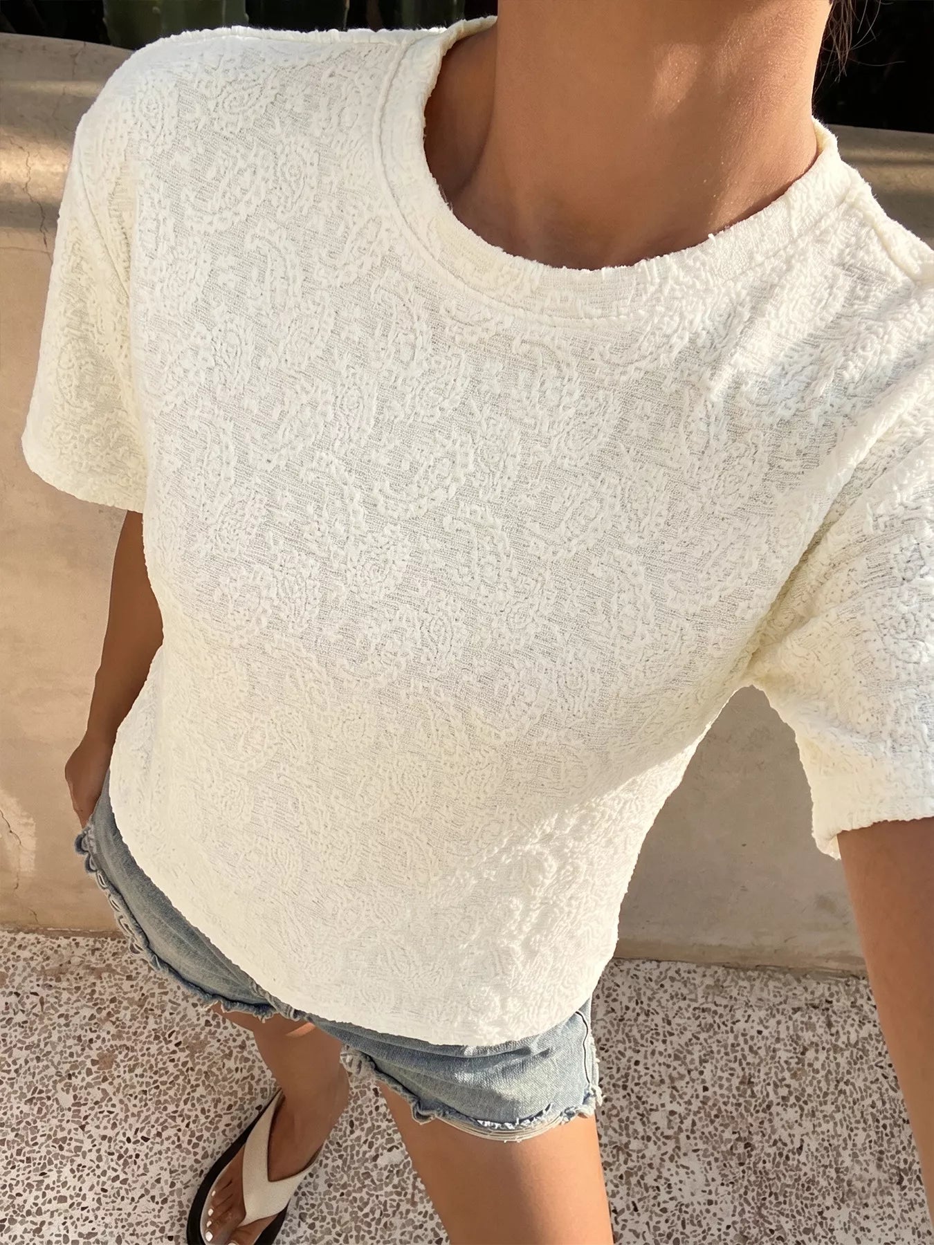 Textured paisley pattern casual T-shirt from Trendsi, showing a close-up of the stylish print and fabric texture.