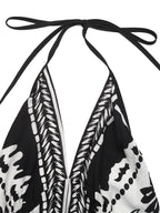 Women's printed halter neck maxi dress with tie-back detail, stylish and flowing, perfect for summer or casual occasions.