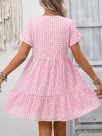 Lightweight plaid V-neck mini dress with ruffle hem from Trendsi, perfect for seasonal fashion, shown in a stylish, casual fit.