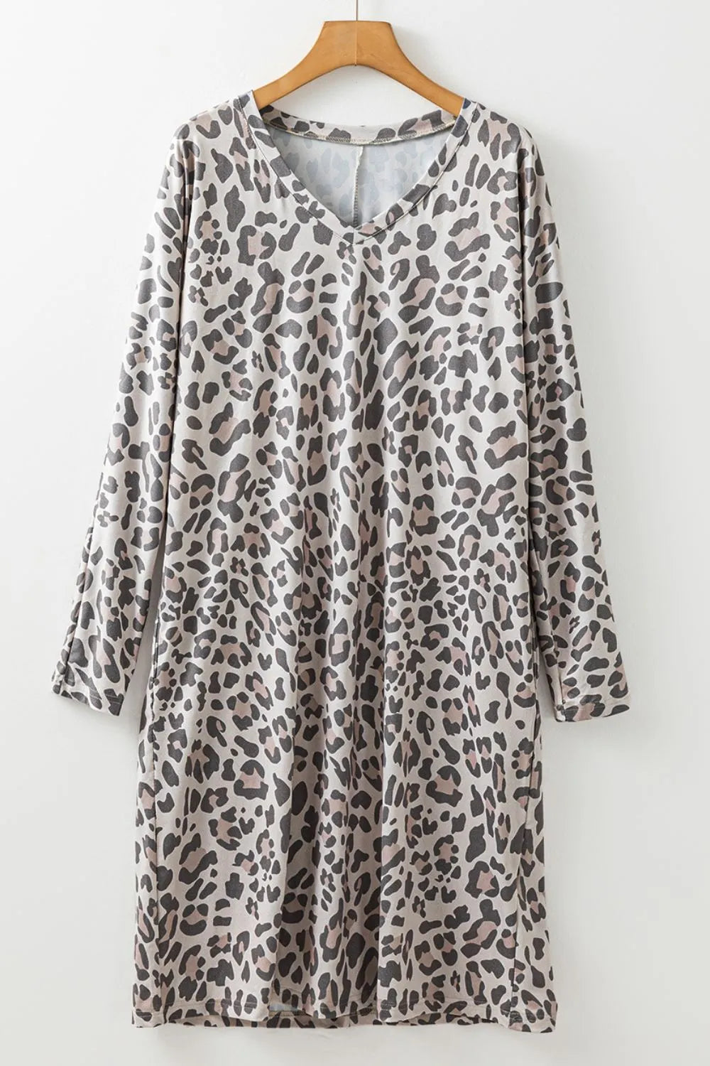 Leopard print V-neck long sleeve dress by Trendsi, featuring a stylish fit and bold animal pattern for a trendy look.