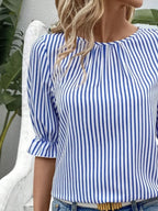 Women's striped ruffled round neck half sleeve blouse from Trendsi, featuring a stylish pattern and feminine ruffle details.
