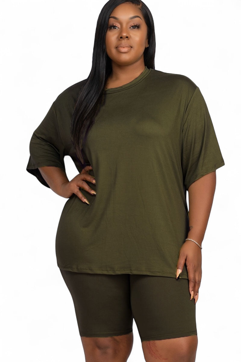 Curvy model wearing an olive green, oversized short-sleeve top and matching bike shorts lounge set.
