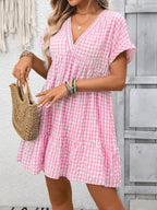 Lightweight plaid V-neck mini dress with ruffle hem from Trendsi, perfect for seasonal fashion and casual occasions.