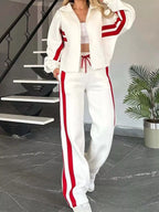 Plus size contrast stripe zip-up jacket and pants set from Plush Fashion Hub, featuring bold stripes and activewear style.