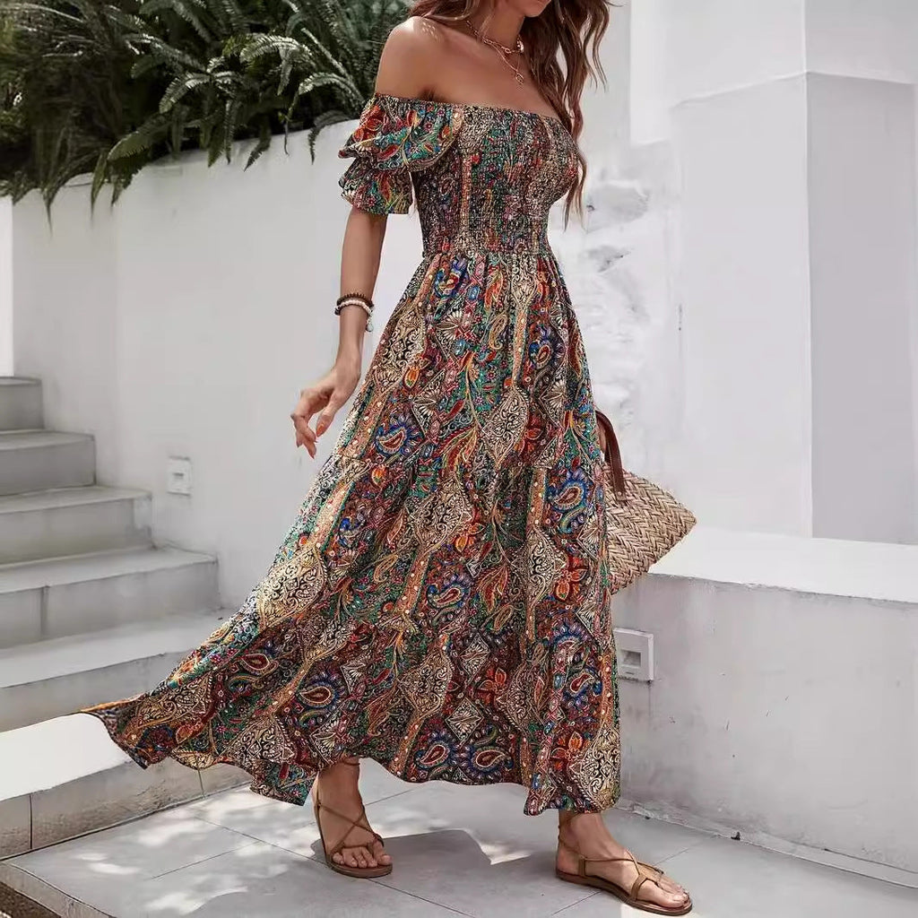 Boho-style off-the-shoulder maxi dress with a colorful, intricate paisley print and a smocked, fitted bodice.