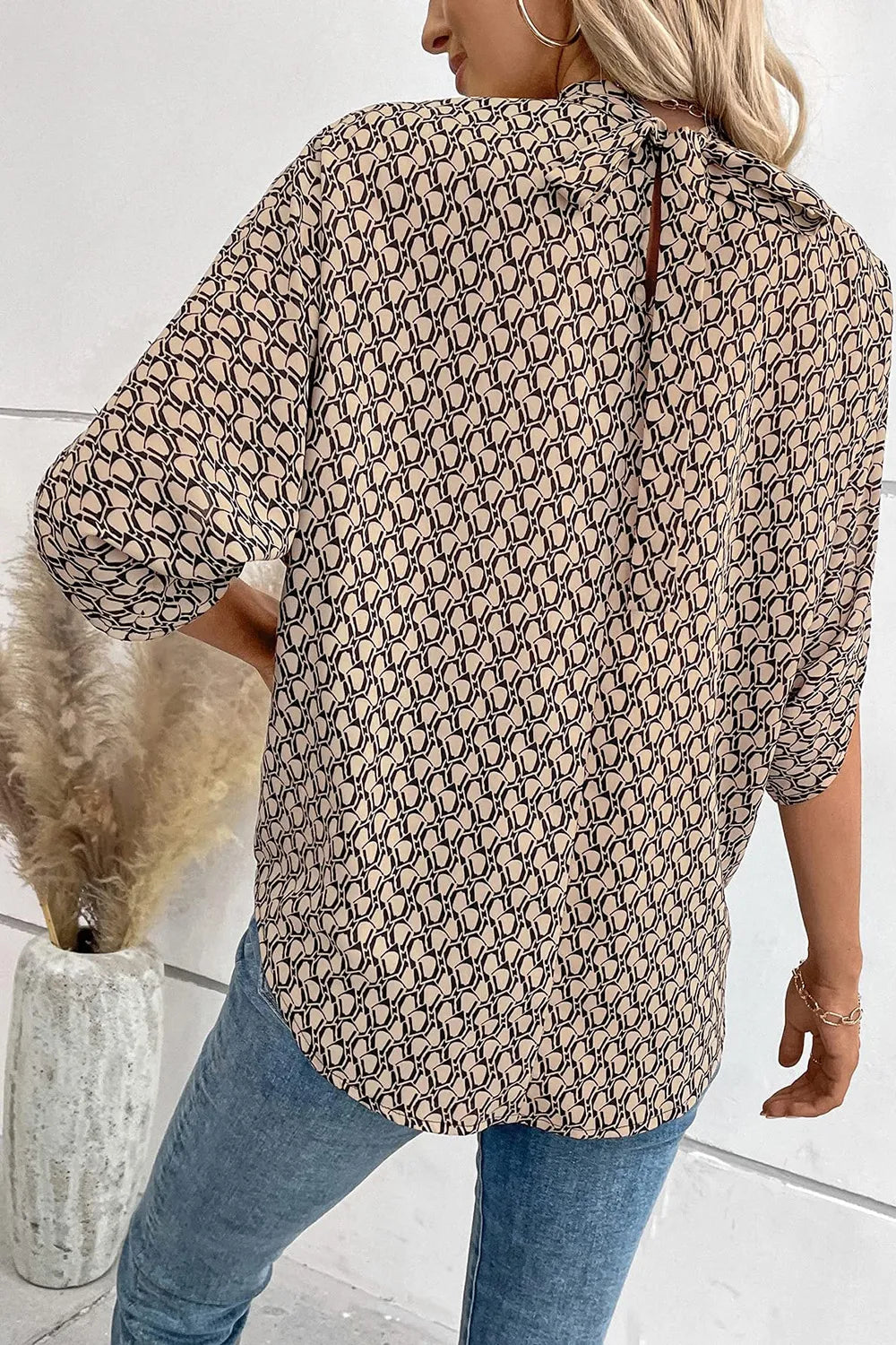 Elegant tie-back half-sleeve blouse with side slit from Trendsi, featuring a stylish design and comfortable fit.