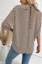 Elegant tie-back half-sleeve blouse with side slit from Trendsi, featuring a stylish design and comfortable fit.