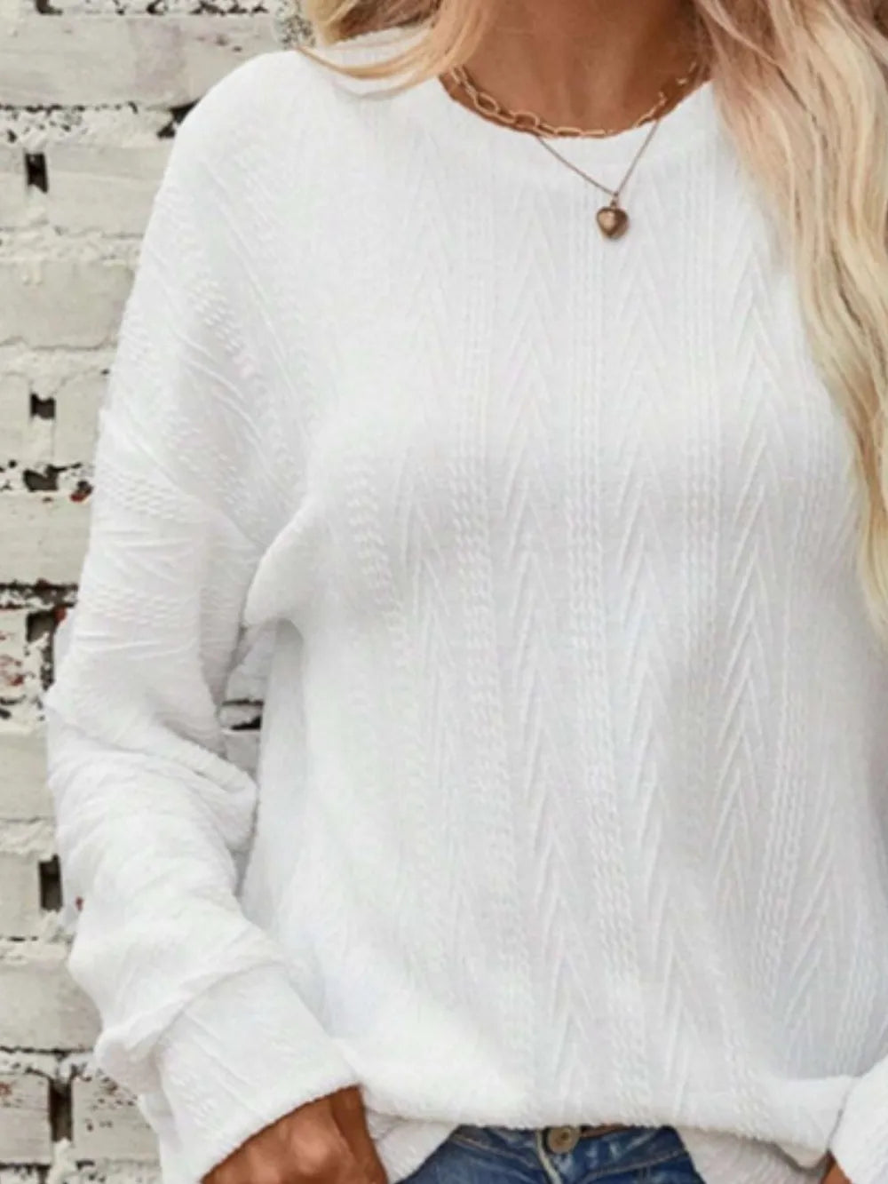 Textured round neck long sleeve T-shirt by Trendsi, showing close-up of fabric detail and classic fit in a natural pose.