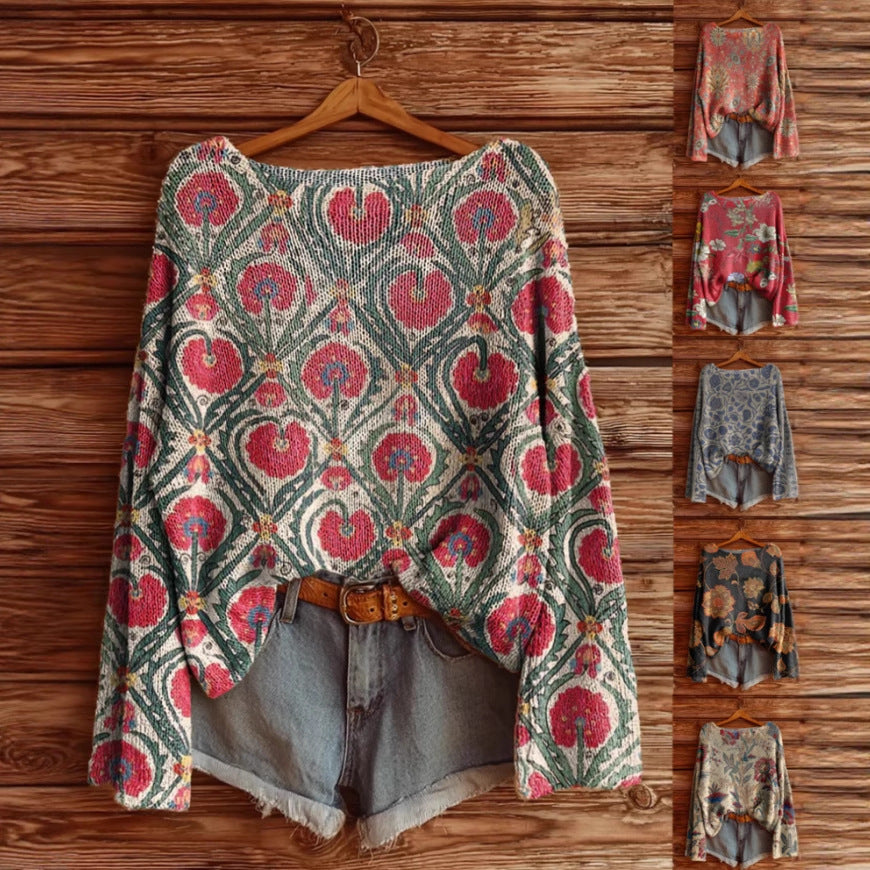 Oversized knit sweater featuring a vintage floral print in shades of pink, green, and cream on a wooden background.