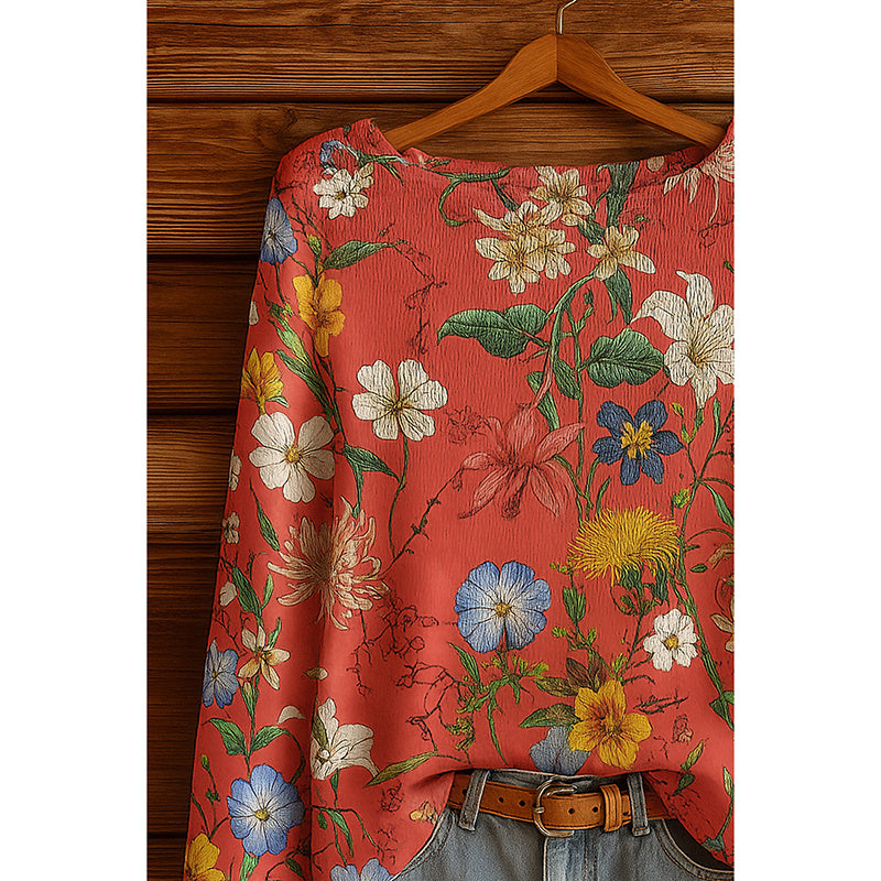 Red long-sleeve blouse with a vibrant, multi-colored floral botanical print and a subtle crinkled texture.