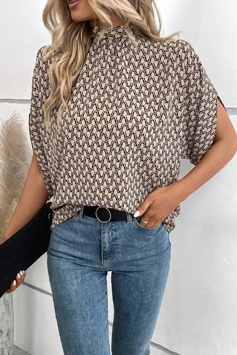 Elegant Trendsi tie-back half-sleeve blouse with side slit, featuring a stylish design and lightweight fabric.