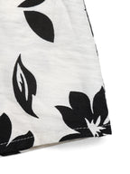 Women's printed halter neck maxi dress with tie-back detail, flowing fabric, and vibrant pattern by Trendsi.