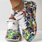 Colorful low-top sneakers with white laces and a vibrant, multi-colored pop art comic book print.