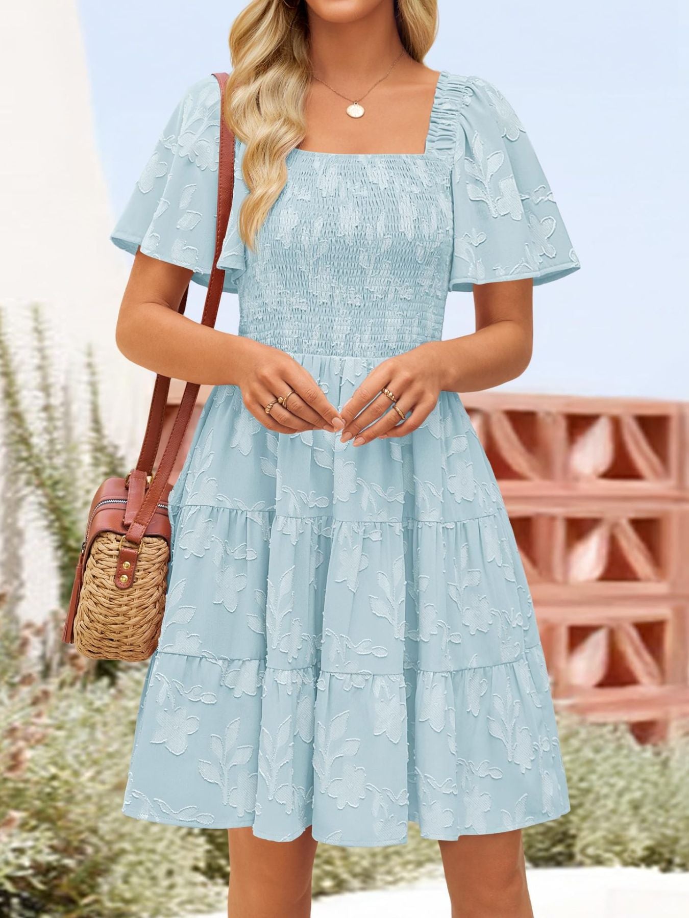 Women's smocked tiered square neck casual dress with short sleeves and pockets, by Trendsi, shown in a stylish, comfortable design.
