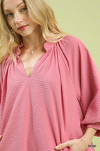 Rose textured balloon sleeve mini dress with pockets from Trendsi, featuring a stylish design and vibrant floral pattern.