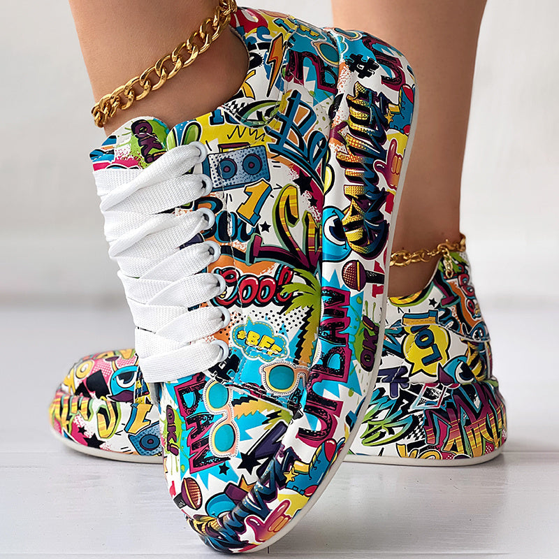 Low-top sneakers with vibrant, multi-colored graffiti print, white laces, and a white rubber sole.